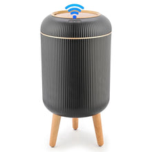 Black automatic trash can with ridged body and motion-sensor lid