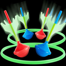 Glow lawn dart set: red, blue, green darts and ring targets.