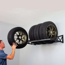 Wall-mounted tire rack with black brackets and bar for holding two tires