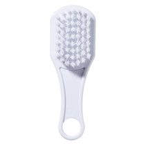 White baby hair brush with patterned bristle pad and loop handle
