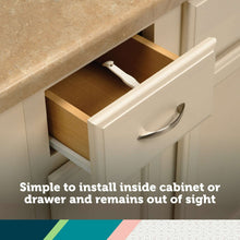 White cabinet drawer latch installed inside drawer, concealed from view