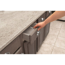 Cabinet and drawer latch inserted under countertop edge with hand