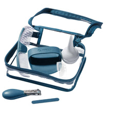Open teal grooming kit pouch with baby combs, brush, and small accessories