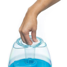 Hand pressing humidifier top lid on blue water tank