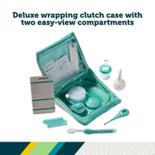 Teal deluxe wrapping case open with brush, comb, nail tools, and kit documents
