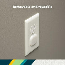 White plug protectors installed on wall outlet; removable cap covers