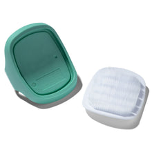 Aqua cradle cap brush with flip-open base and soft white bristle pad