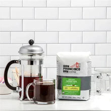 Ground coffee bag with French press and glass cups