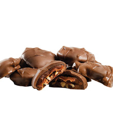 Milk chocolate caramel clusters with pecan filling, open bite pieces