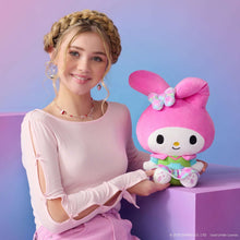 My Melody neon plush doll held by person, pink bunny hood with plaid bow and dress