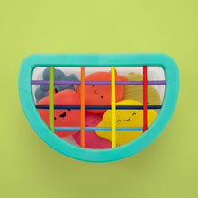 Teal scoop frame of fruit fill-and-spill STEM toy with colorful bars and faces