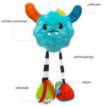 Plush blue Yeti baby toy with orange ear, striped legs, and textured ribbon accents