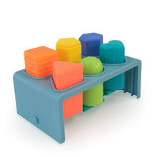 Blue press-and-pop bench corner view with orange, yellow, green, and blue blocks
