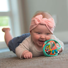 Baby reaching for teal and orange sensory busy ball with bead and ring tracks