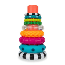 Stacking ring toy with colored rings, striped and textured pieces on clear posts