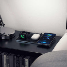 Wireless charging dock with smartwatch, earbuds, and phone on dual charging pads