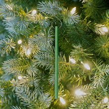 Green scented stick ornament with hanging loop on evergreen branches