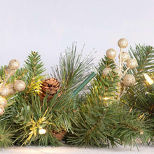 Scented stick ornament inserted into evergreen branches with small decorative lights