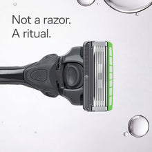 Razor head with blade cartridge on black handle with green accent stripe