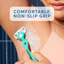 Teal handheld razor shaving skin with lather and gripped handle