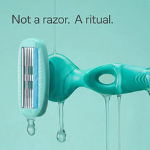Turquoise razor refill head with multiple blades and protective cap