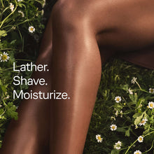 Women’s razor handle shaving on skin with “Lather. Shave. Moisturize.” text