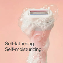 Razor head dispensing lather over skin, with 4-blade cartridge
