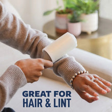Lint roller clearing hair and lint from a knit sweater sleeve