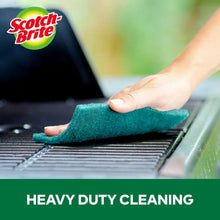 Green heavy-duty scour pad scrubbing a grill grate