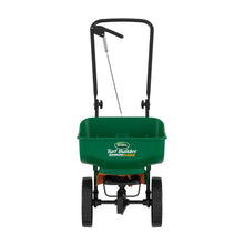 Green Scotts Turf Builder mini broadcast spreader with handle and hopper, four wheels