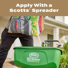 Scotts Turf Builder spreader applying lawn weed and feed from bag, green spreader