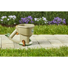 Hand-powered spreader with beige body, green base, and orange side lever