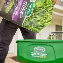 Weed & feed bag tipped over green spreader tub