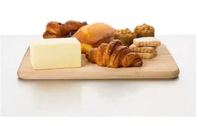 Unsalted sweet cream butter block with pastries on a board