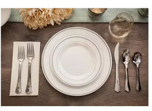 White plastic dinner plates with cutlery layout, set of round plates
