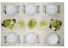 Round white plastic plates with silver utensils, multiple place settings