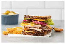 Turkey sandwich with sliced oven-roasted turkey, cheese, lettuce, and tomato