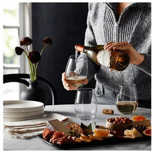 Stemless crystal wine glasses set, wine being poured into a clear cup