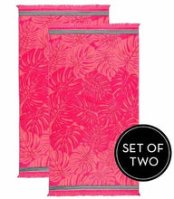Set of two beach towels with pink tropical leaf print and striped trim, fringe ends.