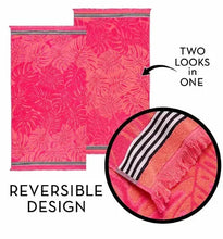 Beach towel with pink tropical leaf pattern and contrasting striped accent trim.