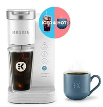 White single-serve pod coffee maker with glass cup, iced & hot indicator, and blue mug