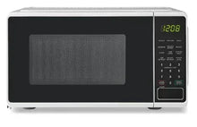 White countertop microwave oven with digital display and keypad controls