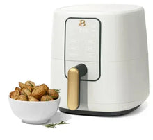 3 qt digital air fryer in white with gold handle and bowl of roasted potatoes