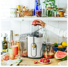 White electric juice extractor with tall transparent feed chute and jug, with control base