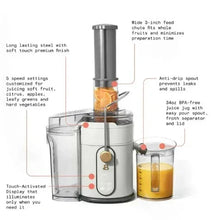 White electric juice extractor with tall feed chute, transparent lid, and juice cup