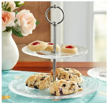 Clear two-tier glass server with cookies on etched plates and chrome ring stand