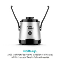 Mini juicer with two upward handles and central control button on silver base.