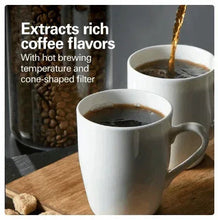 Coffee maker brewing stream into white mugs with dark coffee in cups