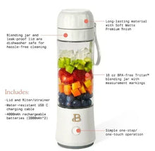 White portable blender jar with handle and lid; fruit and ice pieces in cup