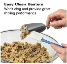 Silver electric hand mixer mixing dough with beaters in glass bowl
